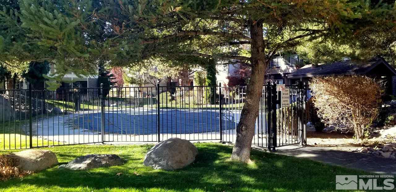 1417 Foster Drive Reno, NV 89509 - Photo 3 of 20 a view of a yard with a tree and wooden fence