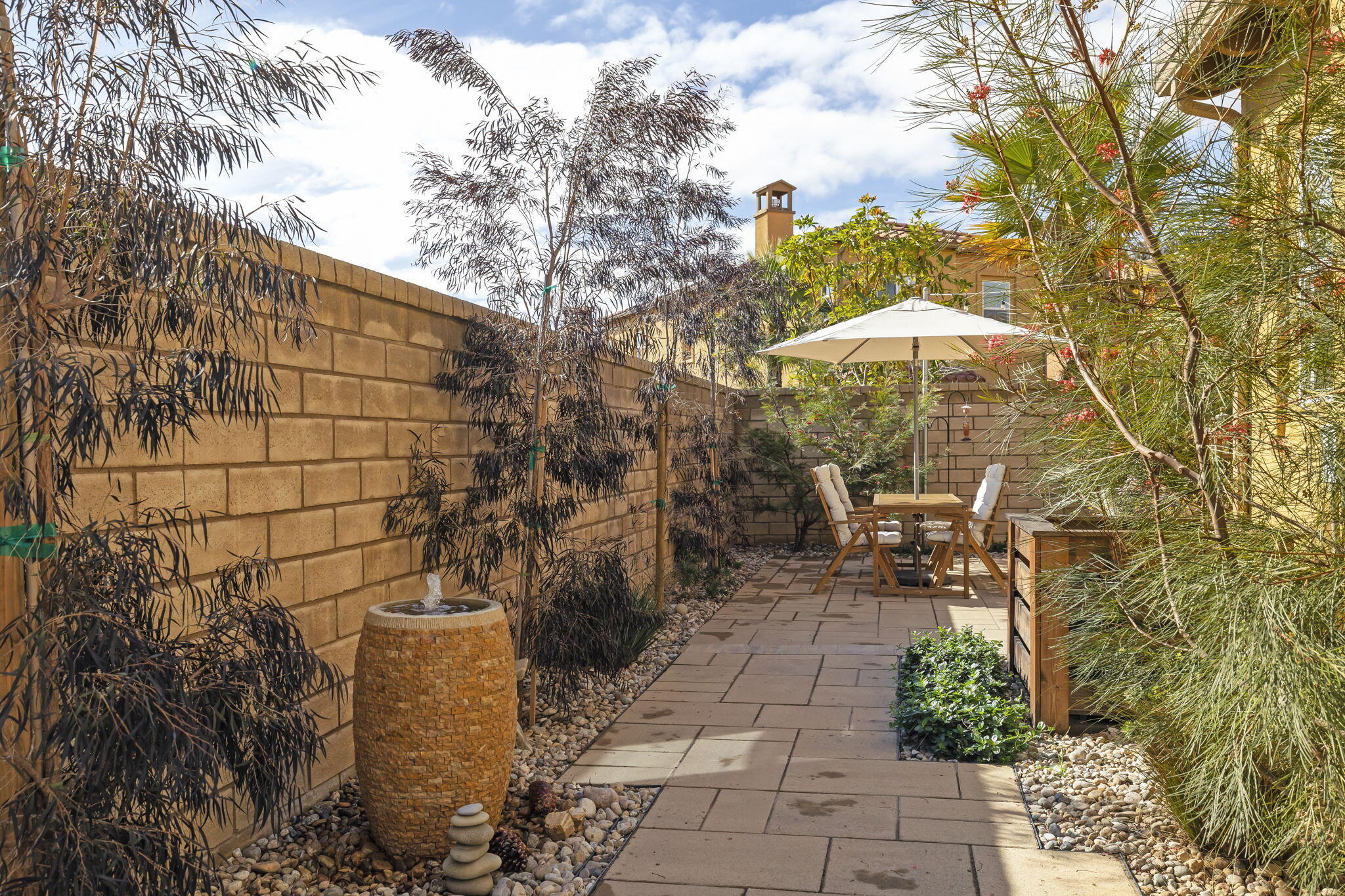 2339 Nicklaus Street Oxnard, CA 93036 - Photo 45 of 50 a view of a patio with table and chairs under an umbrella