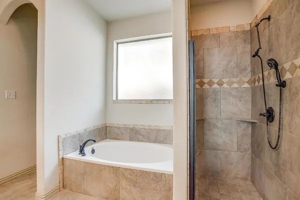 a bath tub sitting next to a shower