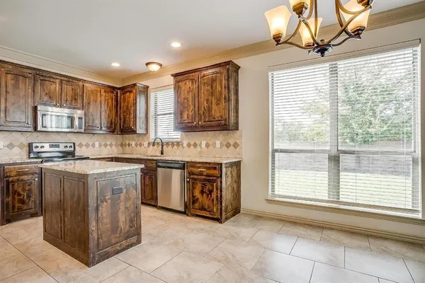 a kitchen with stainless steel appliances granite countertop a stove sink and cabinets