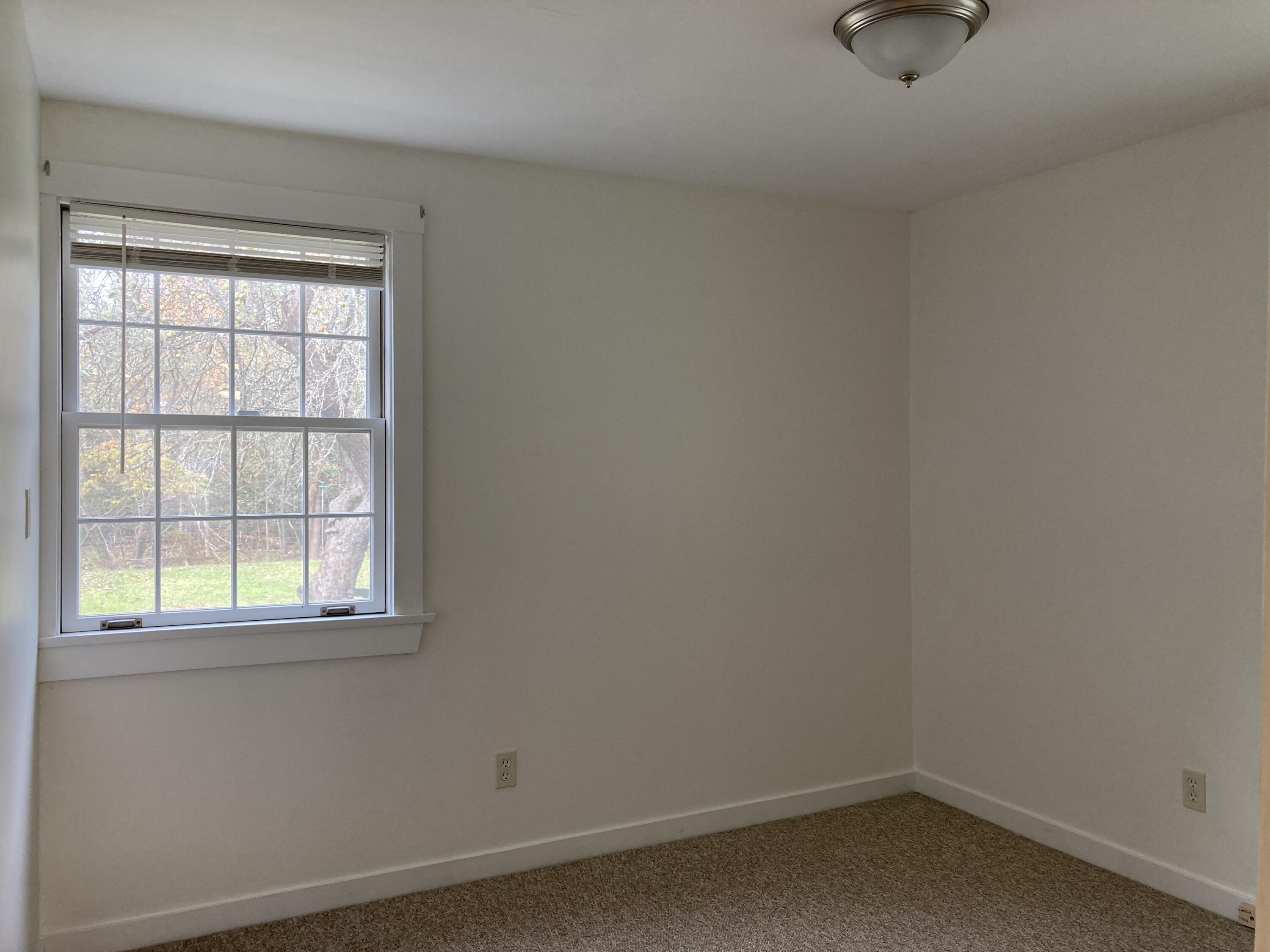 267 East Side Road Hancock, ME 04640 - Photo 7 of 24 First-floor bedroom w/view to backyard.