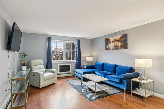 a living room with furniture flat screen tv and a fireplace