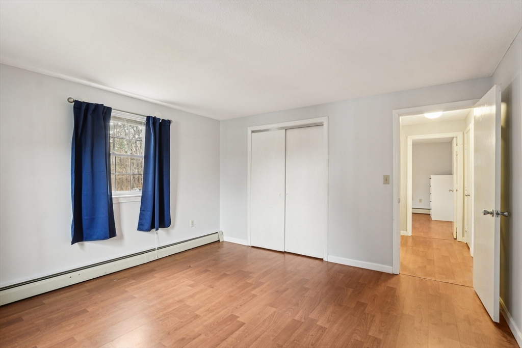 3 Drummer Road, Unit B3 Acton, MA 01720 - Photo 11 of 16 a view of an empty room with wooden floor and a window