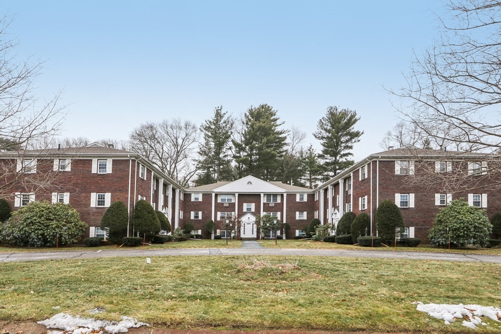 3 Drummer Road, Unit B3 Acton, MA 01720 - Photo 14 of 16 a front view of a building with a garden and plants