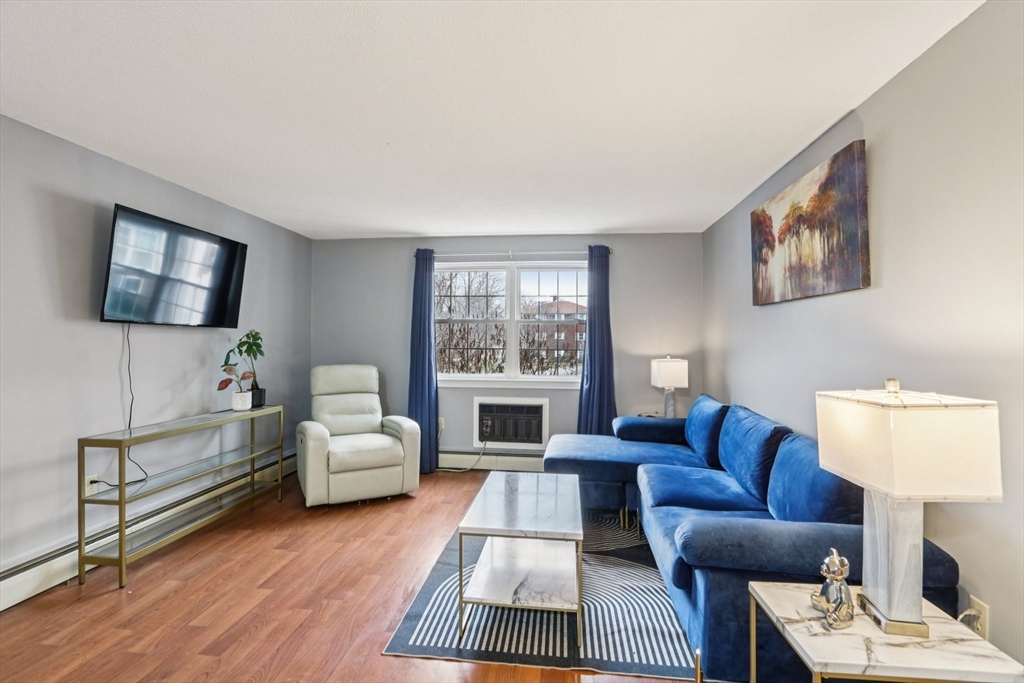 3 Drummer Road, Unit B3 Acton, MA 01720 - Photo 2 of 16 a living room with furniture a window and a flat screen tv