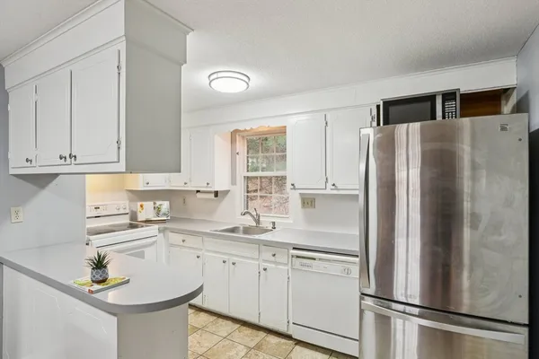 a kitchen with stainless steel appliances a refrigerator sink and cabinets