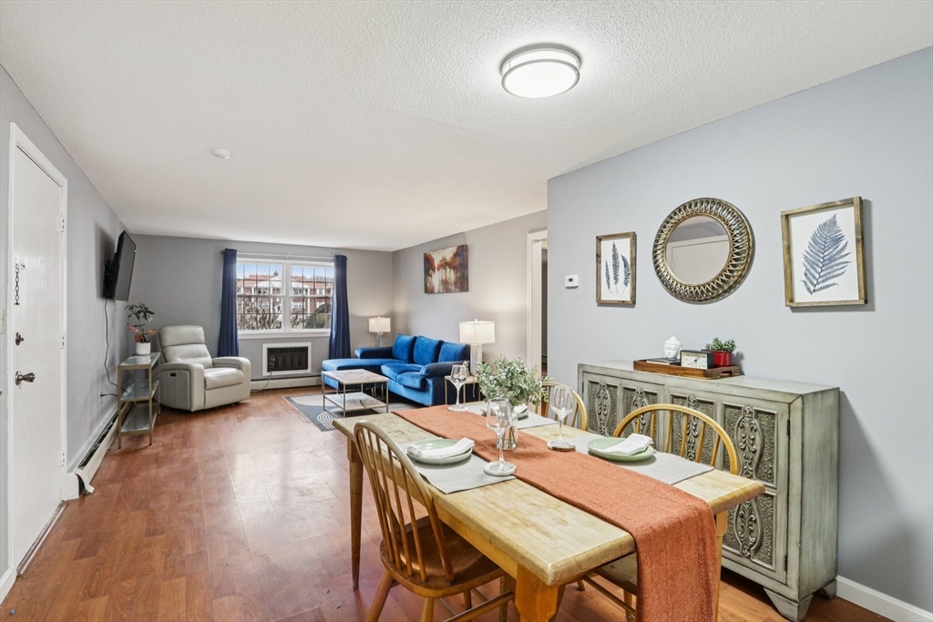 3 Drummer Road, Unit B3 Acton, MA 01720 - Photo 7 of 16 a view of a dining room with furniture a potted plant and wooden floor