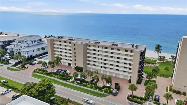 a view of a hallway with wooden floor and furniture