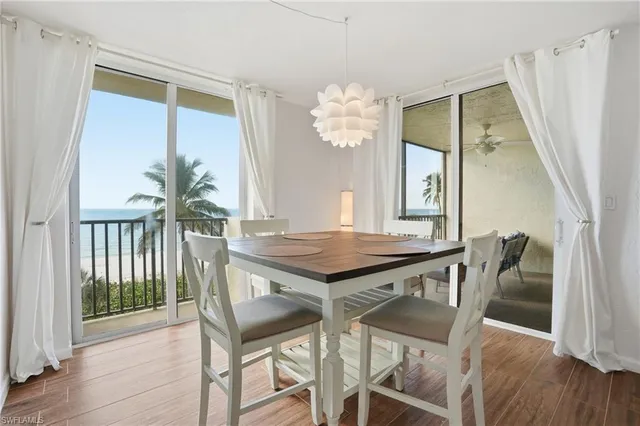 a living room with flat screen tv and dresser