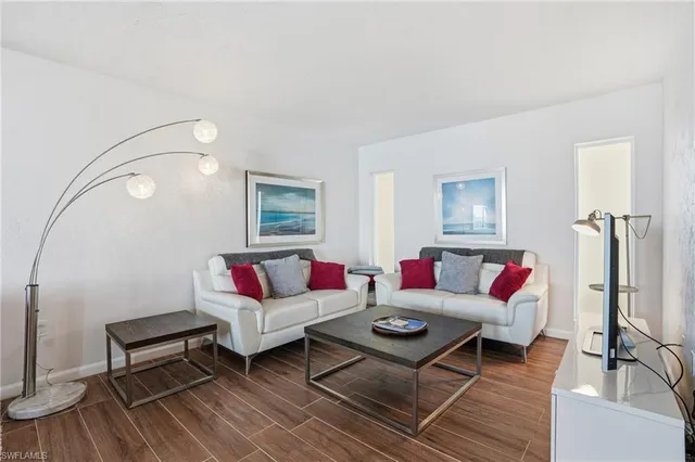 a living room with furniture a rug and a window