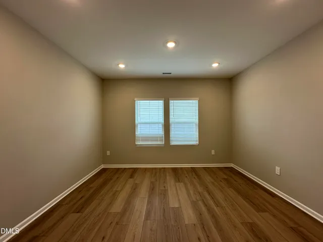 a view of a room with wooden floor and window