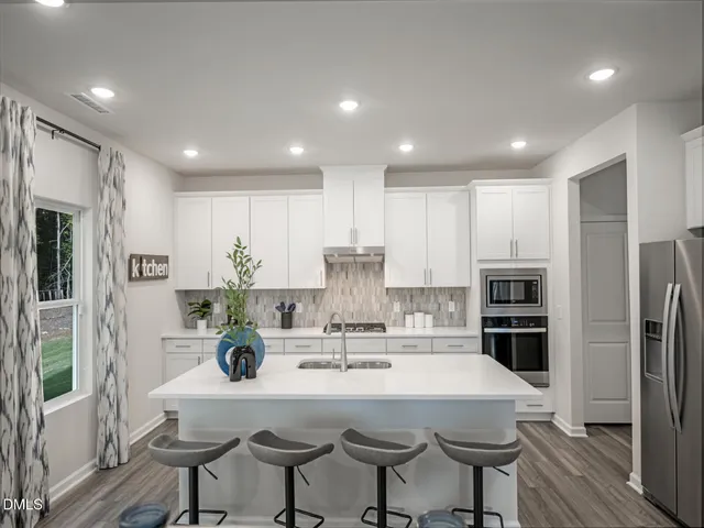 a kitchen with a sink stainless steel appliances and cabinets