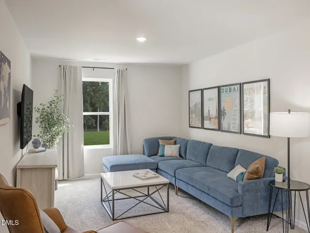 a spacious bedroom with a bed a couch and a view of en suite bathroom