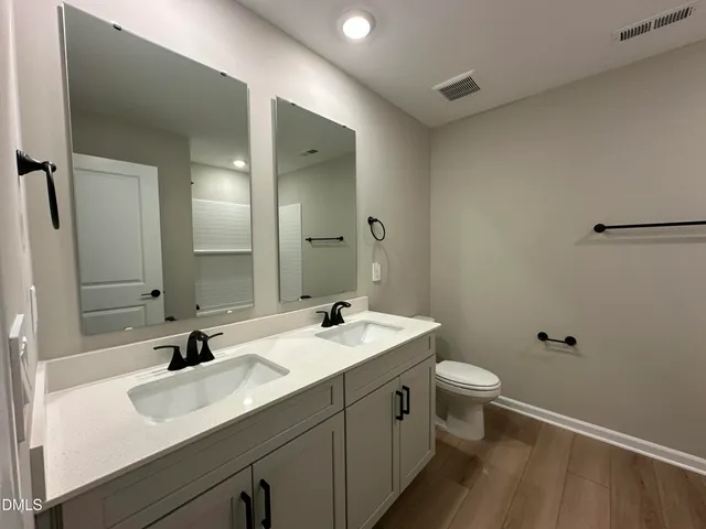 a view of an empty room with window and bathroom