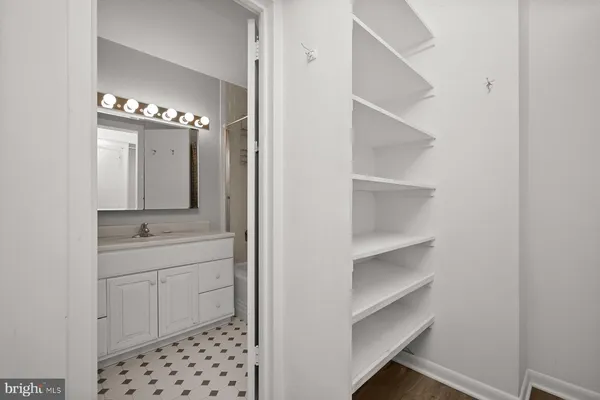 a bathroom with a sink shower and a mirror