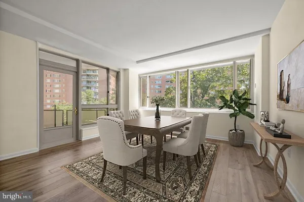 a dining room with furniture wooden floor and a rug