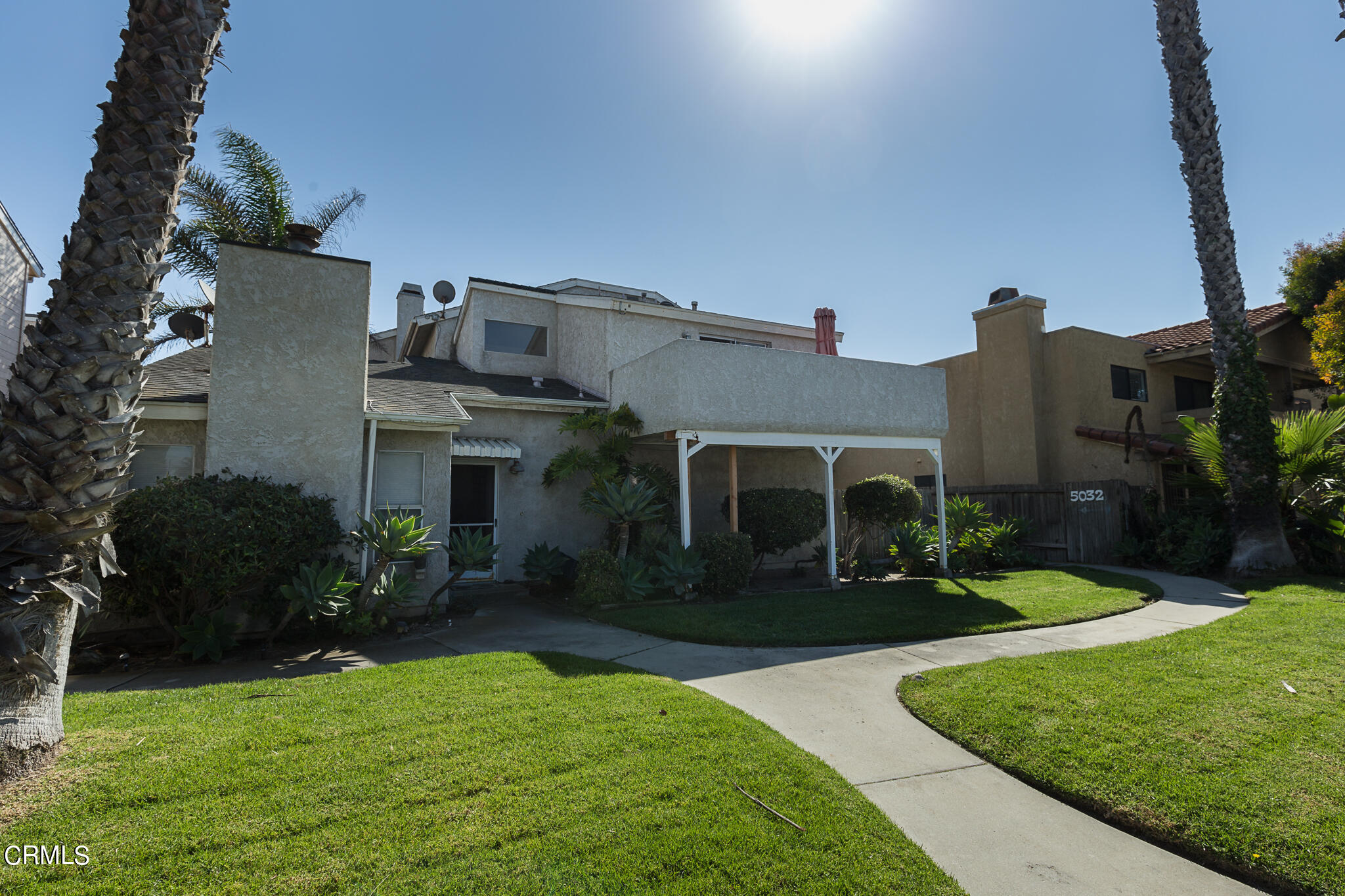 5036 West Wooley Road Oxnard, CA 93035 - Photo 1 of 21 a front view of house with yard and green space