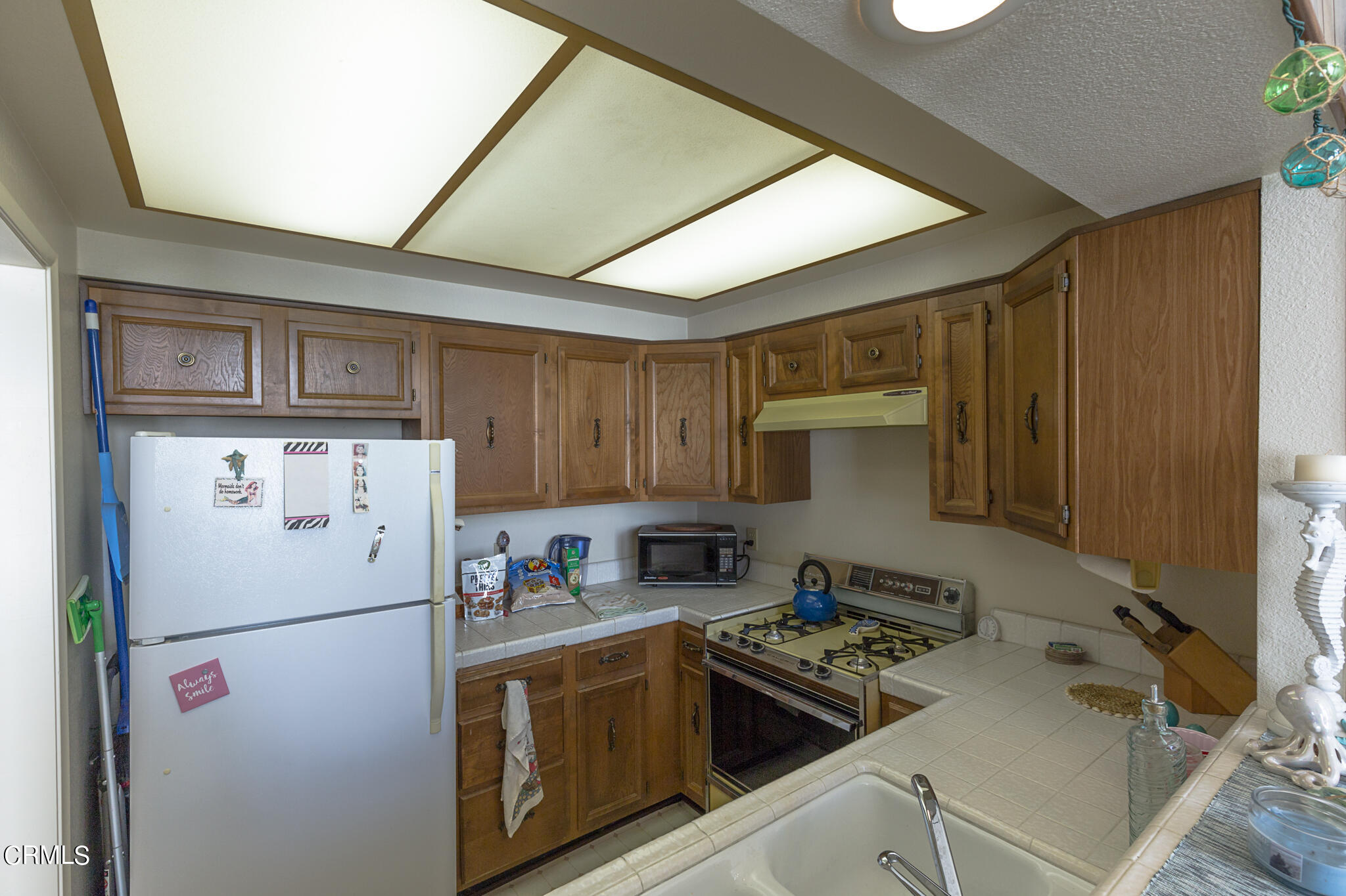 5036 West Wooley Road Oxnard, CA 93035 - Photo 8 of 21 a white refrigerator freezer sitting inside of a kitchen