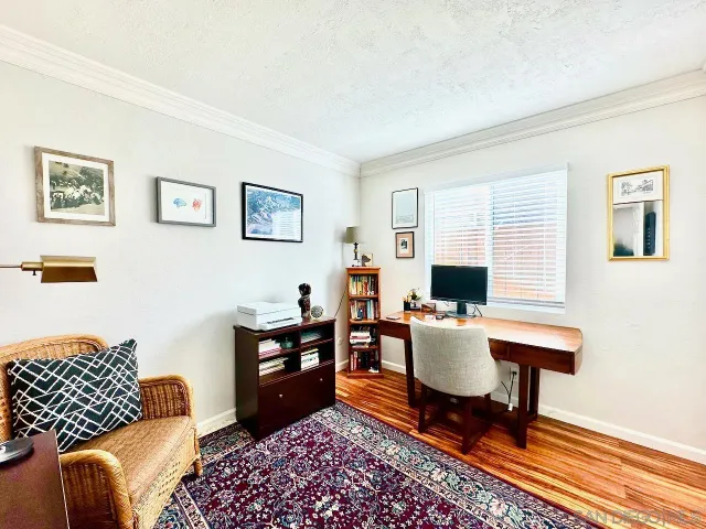 a bedroom with a bed and a lamp on dresser