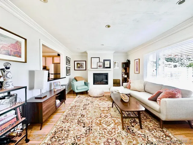 a living room with furniture fireplace and a window