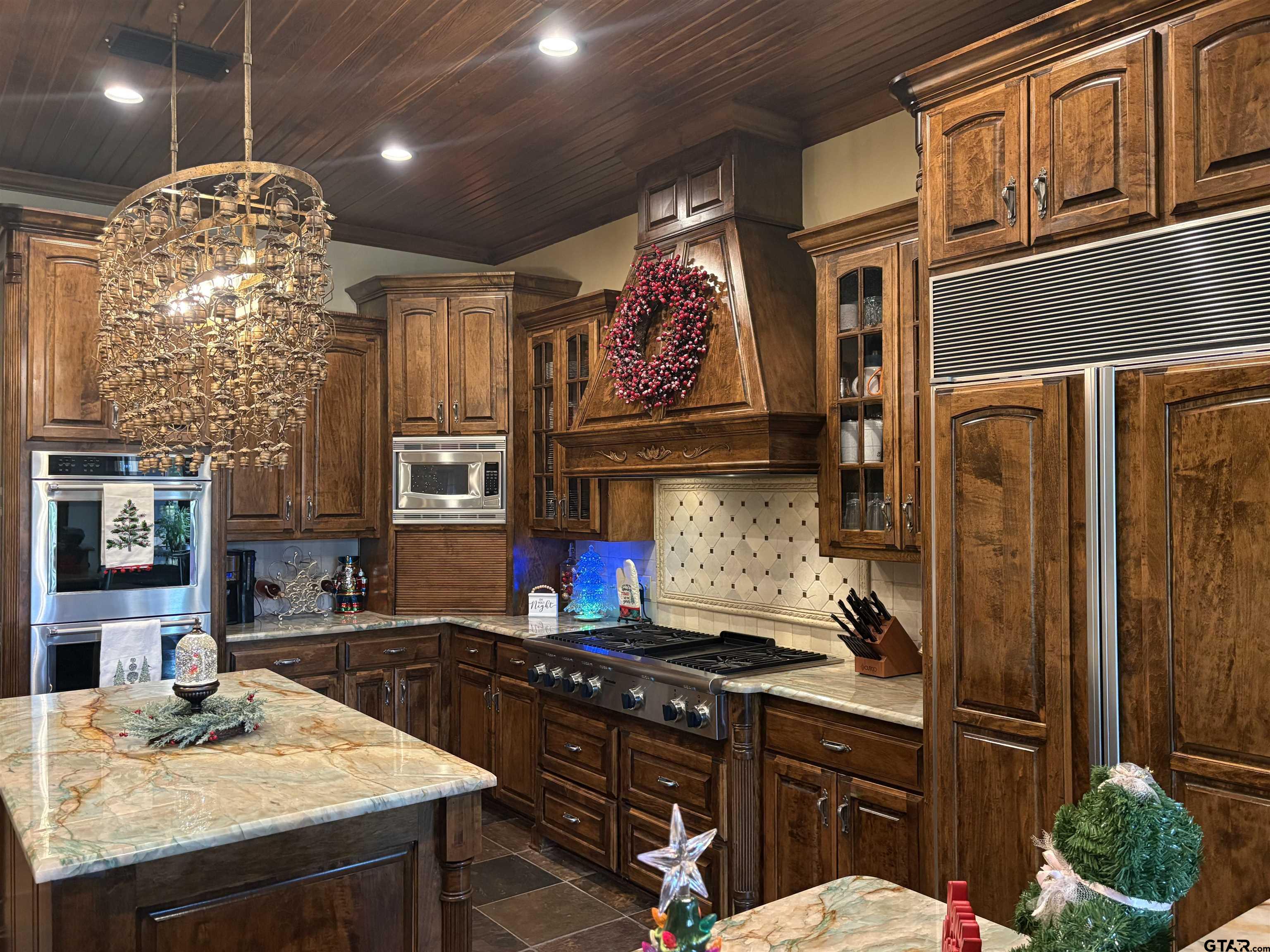 17654 Southpoint Road Whitehouse, TX 75791 - Photo 13 of 47 a kitchen with stainless steel appliances granite countertop a stove a refrigerator a sink dishwasher and wooden cabinets with wooden floor