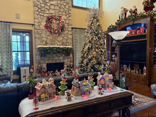 a living room with lots of flowers and a fireplace