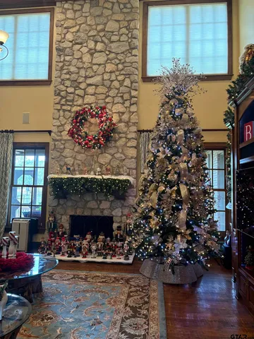 a living room with a fireplace and a potted plant