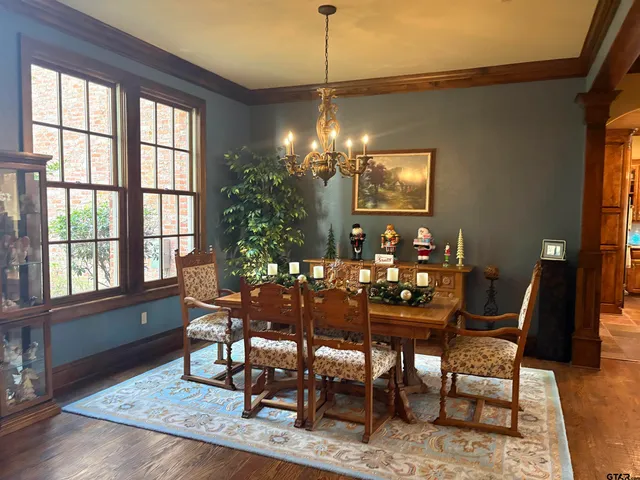 a kitchen with stainless steel appliances granite countertop a stove a refrigerator a sink dishwasher and wooden cabinets with wooden floor