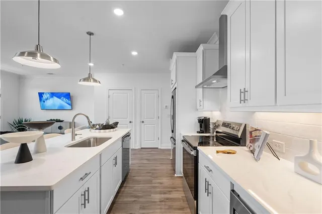 a kitchen with a sink stove and cabinets