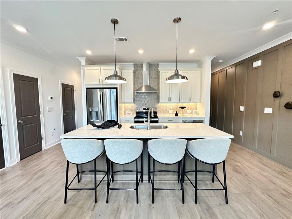 502 Alice Way, Unit D21 Cumming, GA 30040 - Photo 6 of 52 a kitchen with stainless steel appliances a dining table chairs and wooden floor