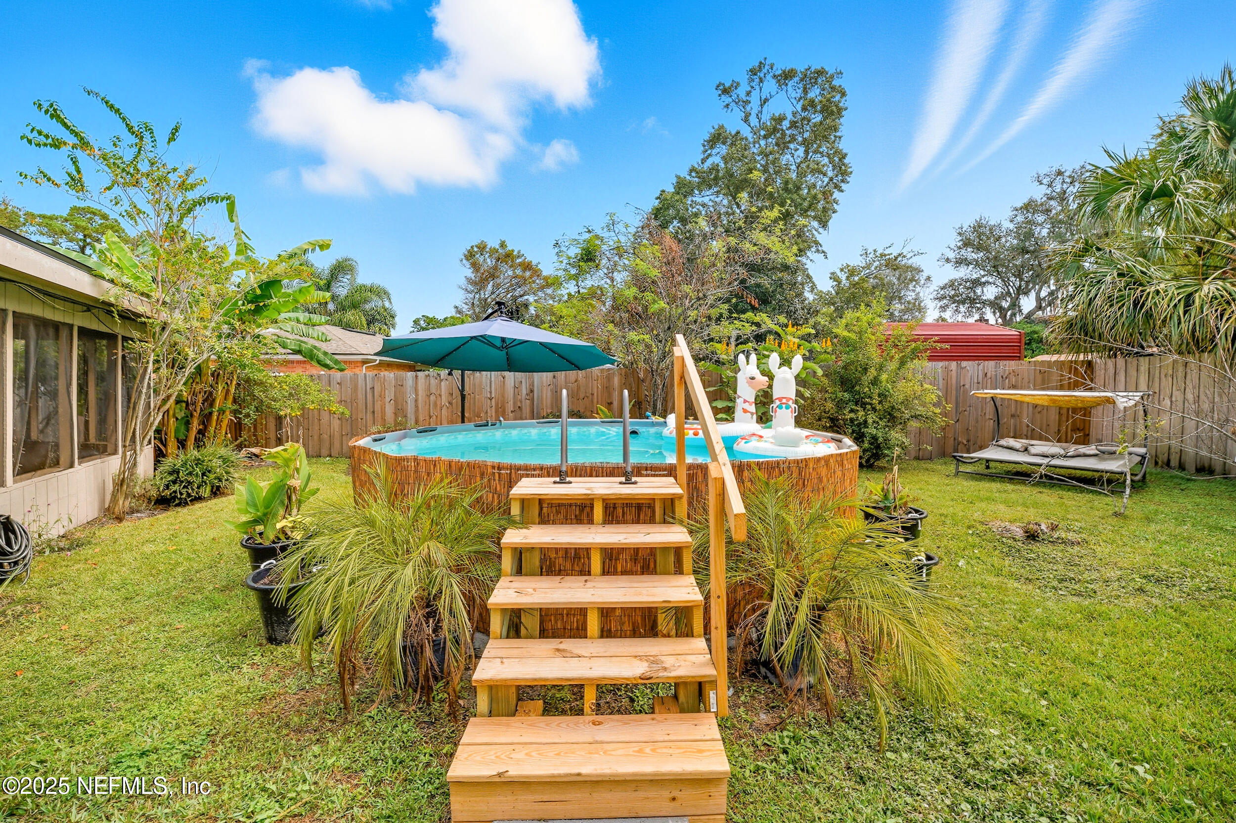 5396 Golf Course Drive Jacksonville, FL 32277 - Photo 14 of 62 a view of a swimming pool with a patio