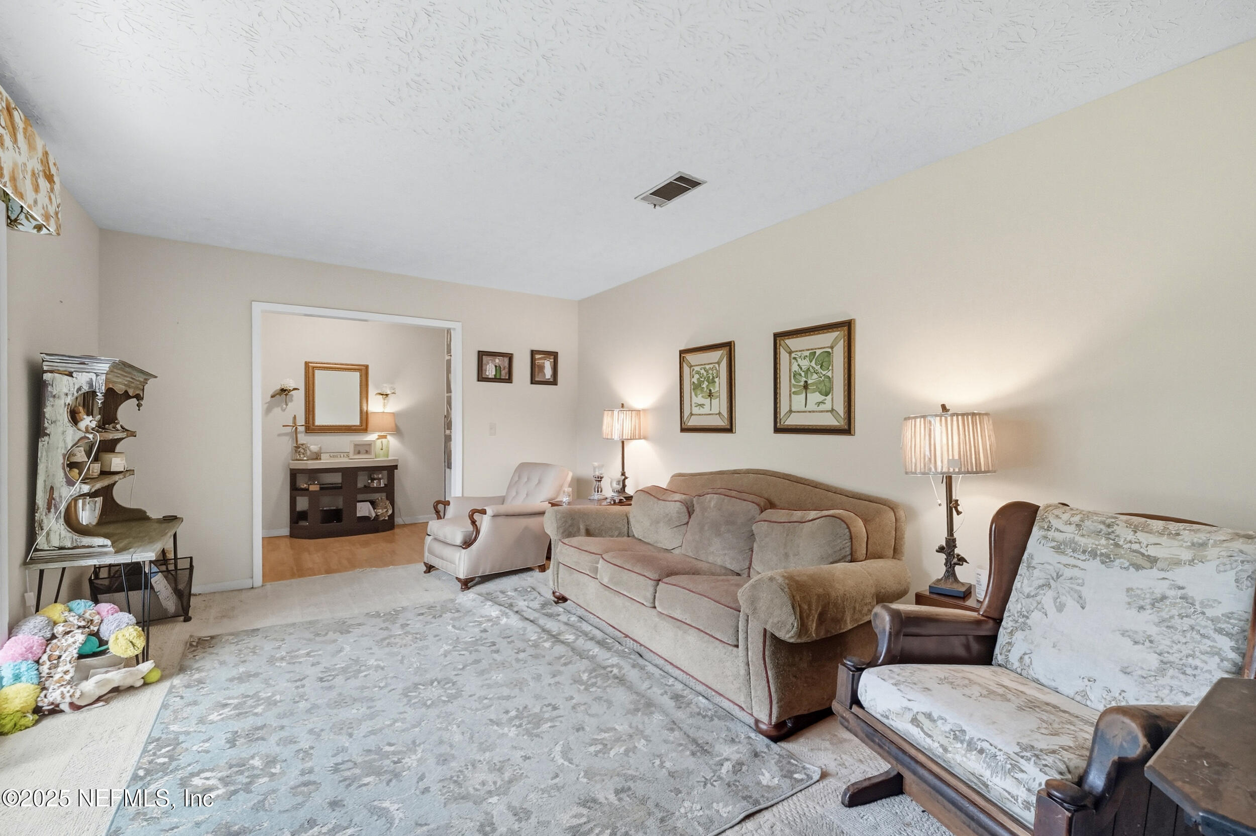 5396 Golf Course Drive Jacksonville, FL 32277 - Photo 16 of 62 a living room with furniture and wooden floor