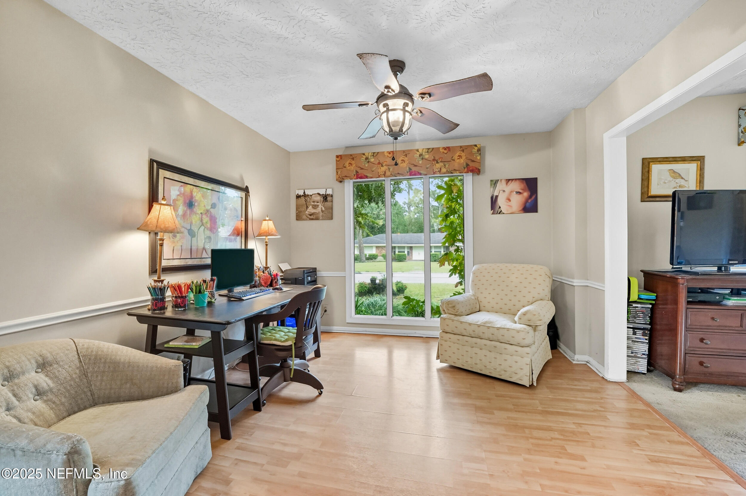 5396 Golf Course Drive Jacksonville, FL 32277 - Photo 18 of 62 a living room with furniture and a flat screen tv