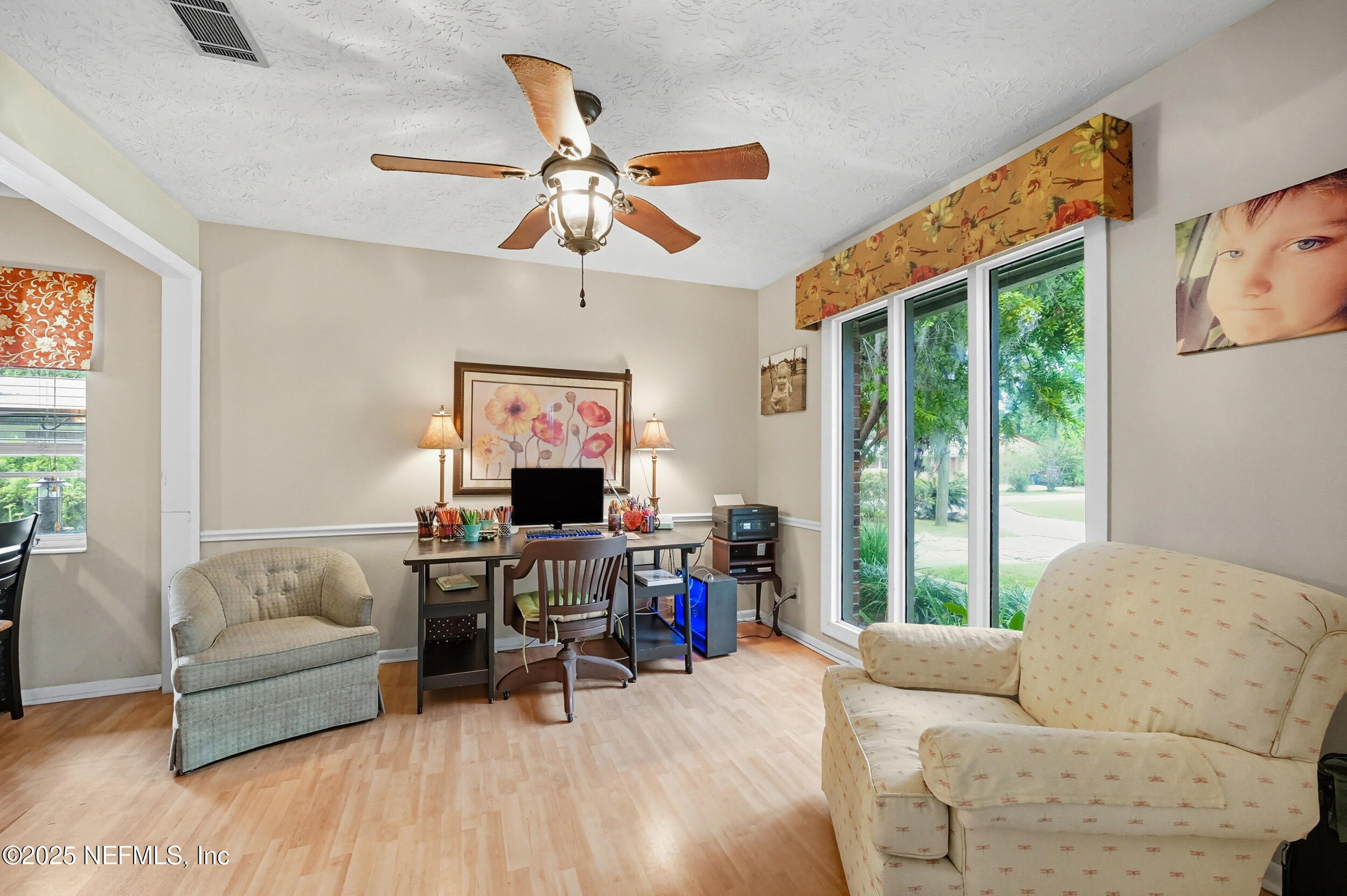 5396 Golf Course Drive Jacksonville, FL 32277 - Photo 19 of 62 a living room with furniture and a flat screen tv