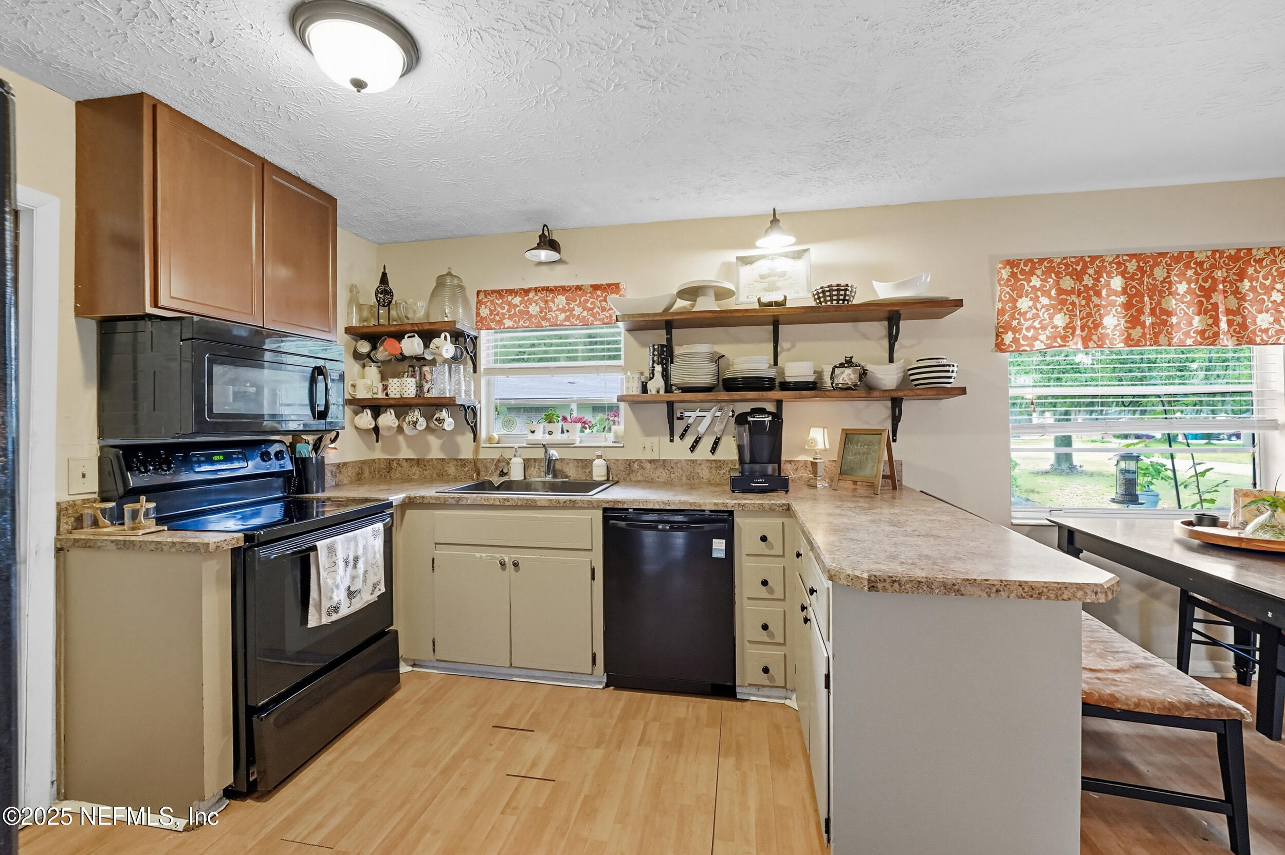 5396 Golf Course Drive Jacksonville, FL 32277 - Photo 20 of 62 a kitchen with stainless steel appliances granite countertop a stove and a sink
