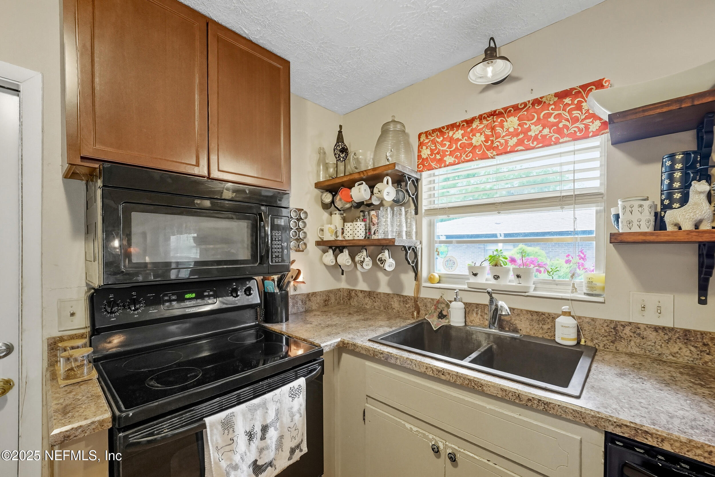5396 Golf Course Drive Jacksonville, FL 32277 - Photo 21 of 62 a kitchen with stainless steel appliances a stove and a microwave
