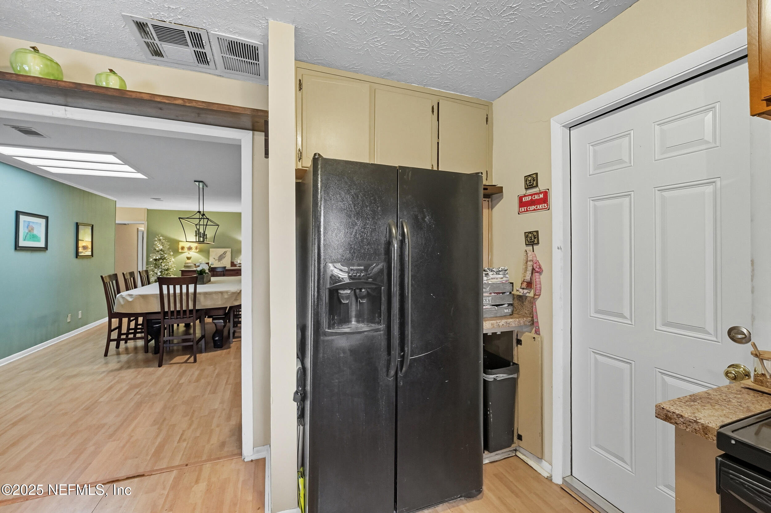 5396 Golf Course Drive Jacksonville, FL 32277 - Photo 22 of 62 a kitchen with refrigerator and table