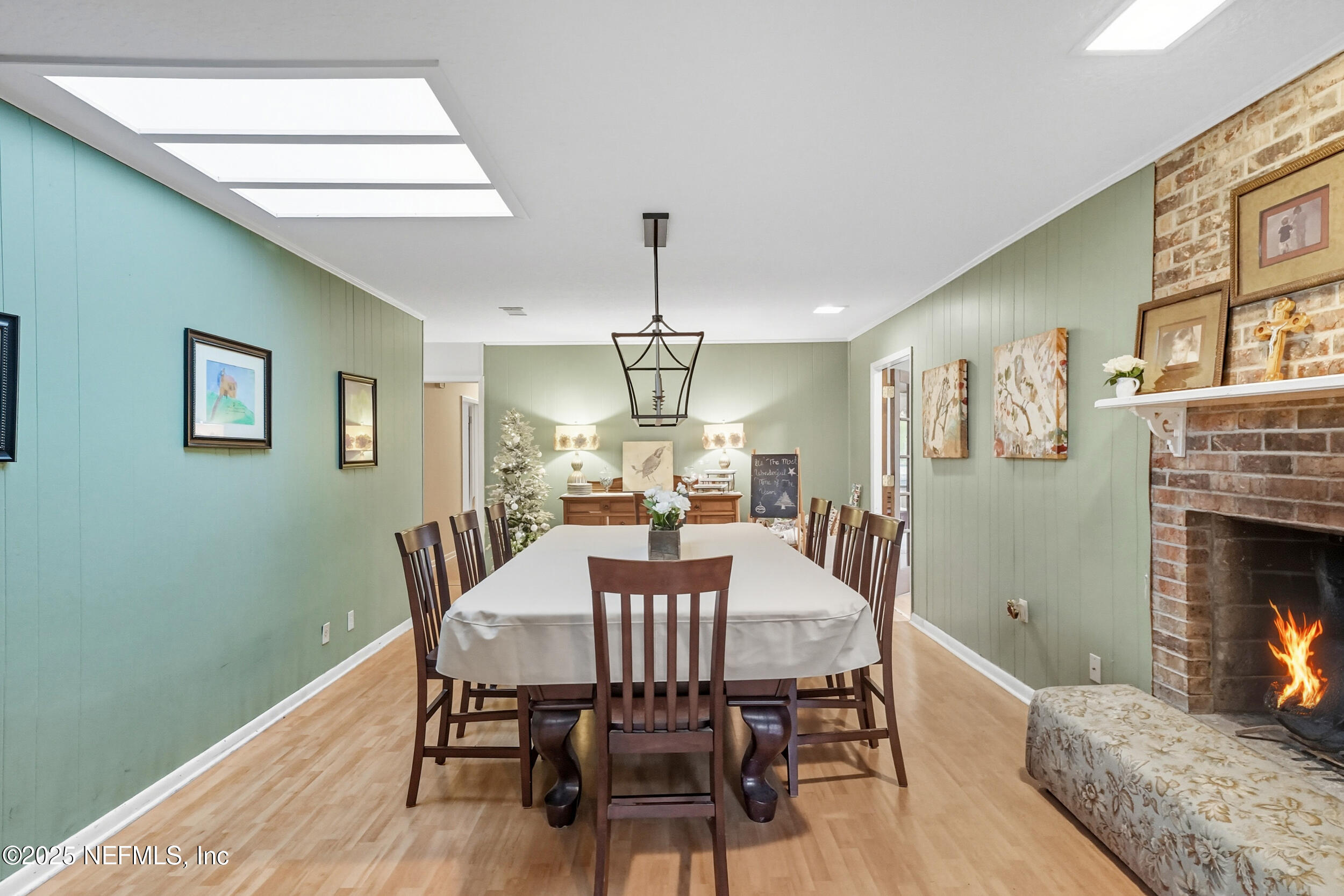 5396 Golf Course Drive Jacksonville, FL 32277 - Photo 25 of 62 a dining room with furniture a chandelier and wooden floor