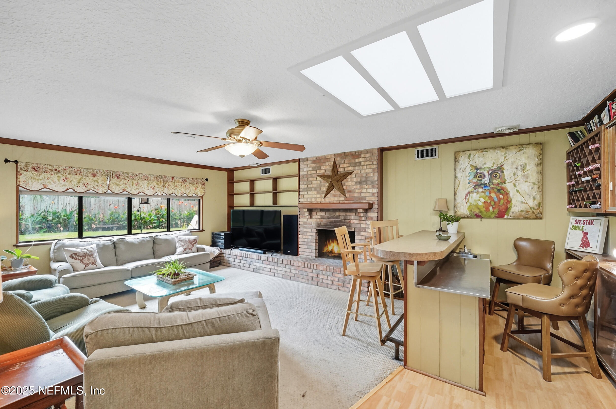 5396 Golf Course Drive Jacksonville, FL 32277 - Photo 28 of 62 a living room with fireplace furniture and a large window