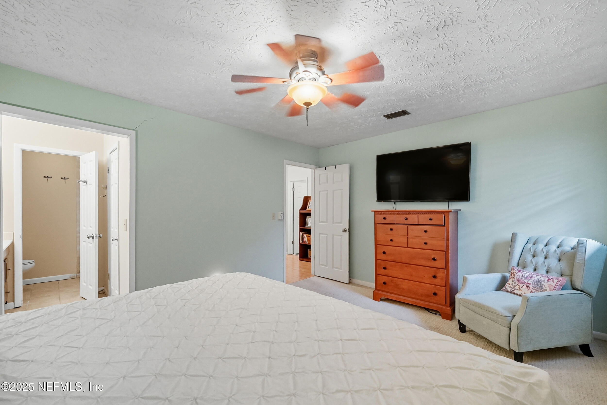 5396 Golf Course Drive Jacksonville, FL 32277 - Photo 30 of 62 a bedroom with furniture and a flat screen tv