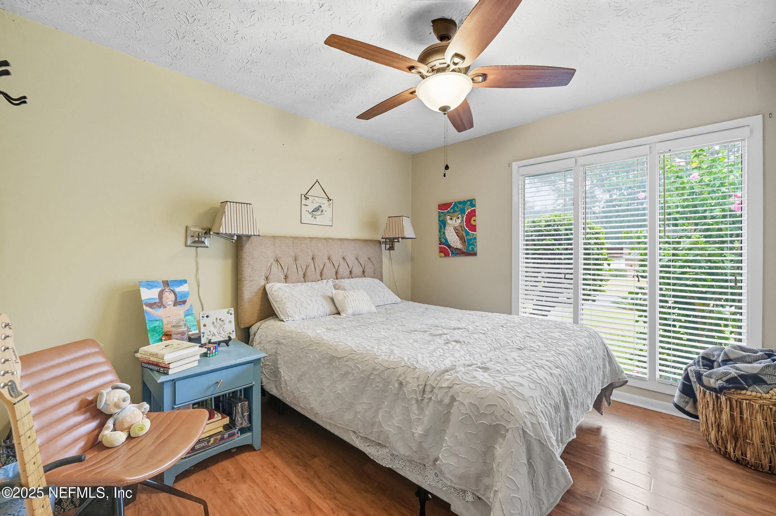 5396 Golf Course Drive Jacksonville, FL 32277 - Photo 35 of 62 a bedroom with a bed and a chandelier