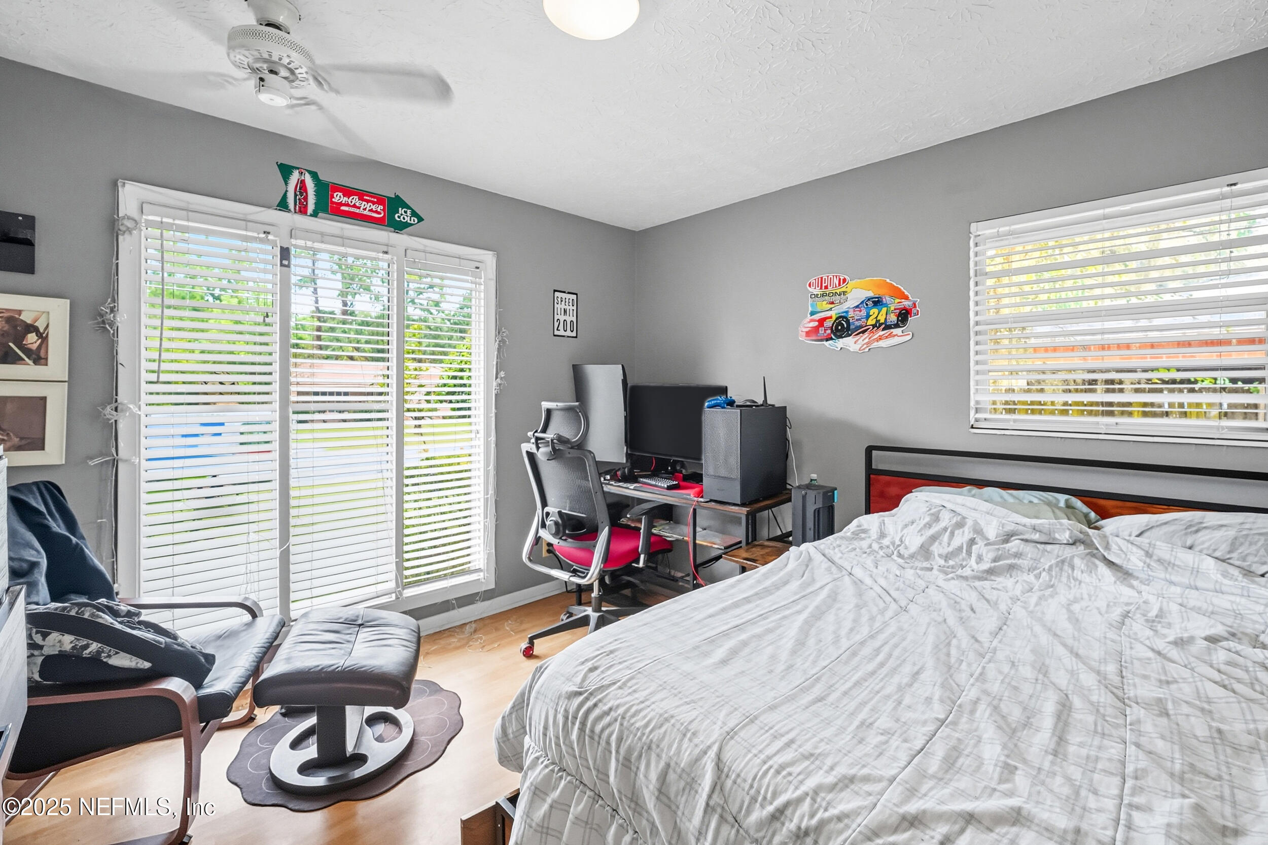5396 Golf Course Drive Jacksonville, FL 32277 - Photo 37 of 62 a bedroom with a bed a dresser and a flat screen tv