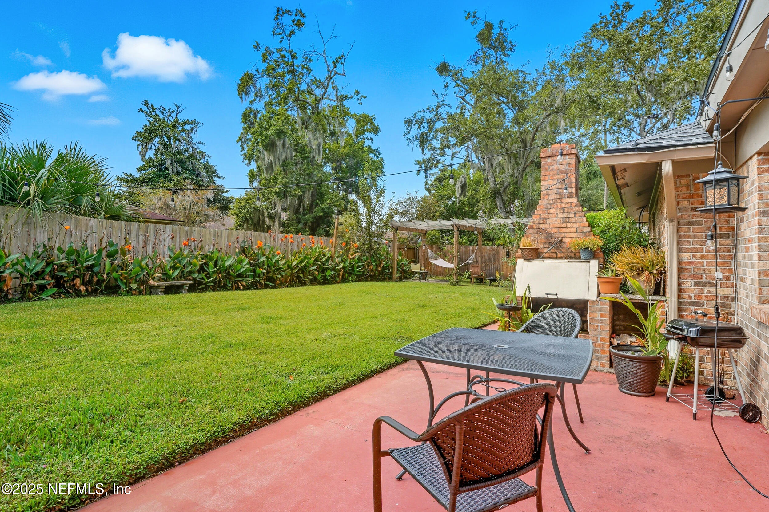 5396 Golf Course Drive Jacksonville, FL 32277 - Photo 38 of 62 a view of a chair and table in the garden