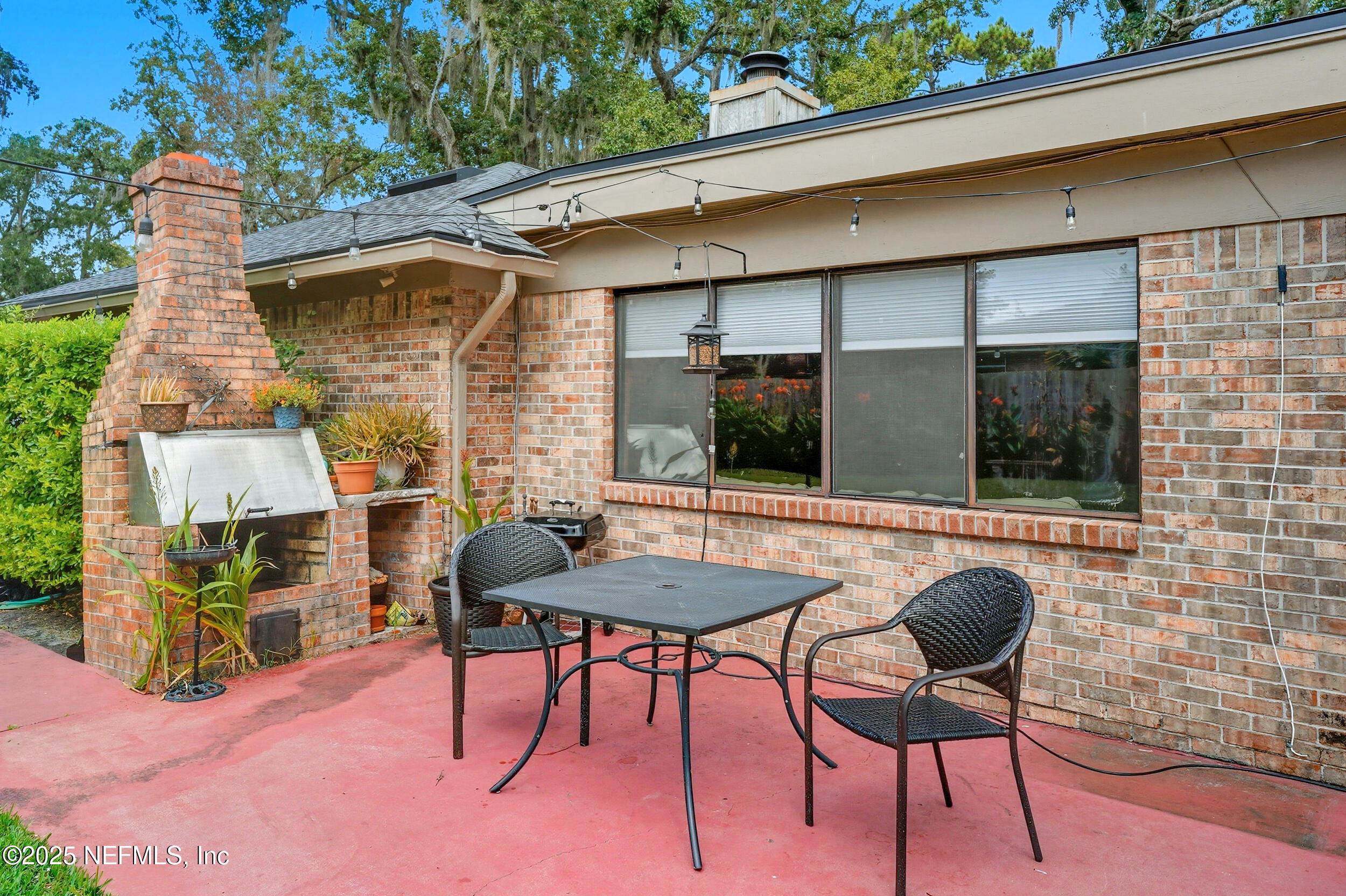 5396 Golf Course Drive Jacksonville, FL 32277 - Photo 39 of 62 a backyard of a house with table and chairs