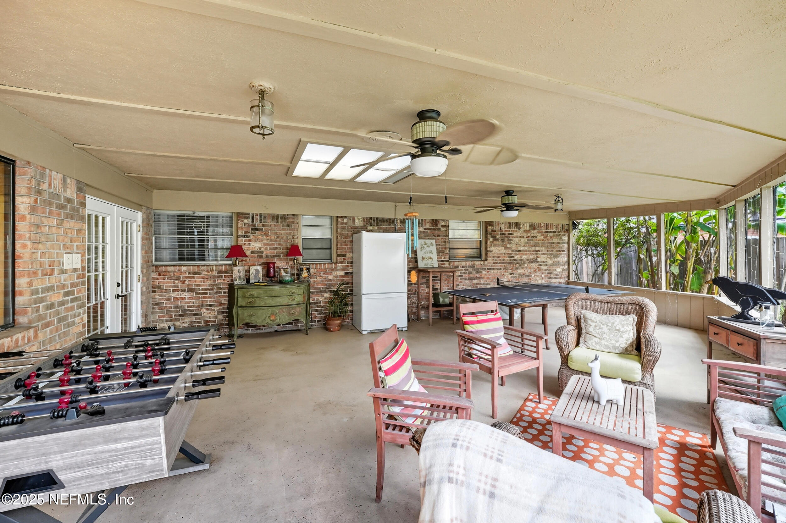 5396 Golf Course Drive Jacksonville, FL 32277 - Photo 6 of 62 a living room with lots of furniture and a chandelier