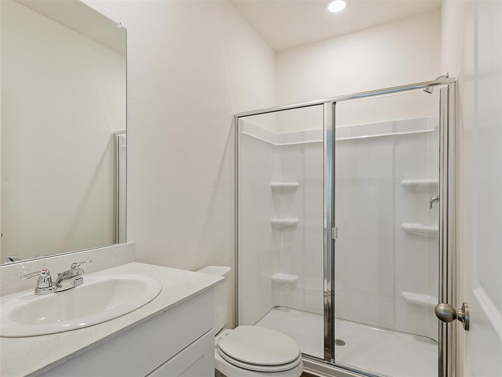 4510 Winecup Road Melissa, TX 75454 - Photo 15 of 22 Bathroom featuring a vanity with an integrated sink and light-colored countertop