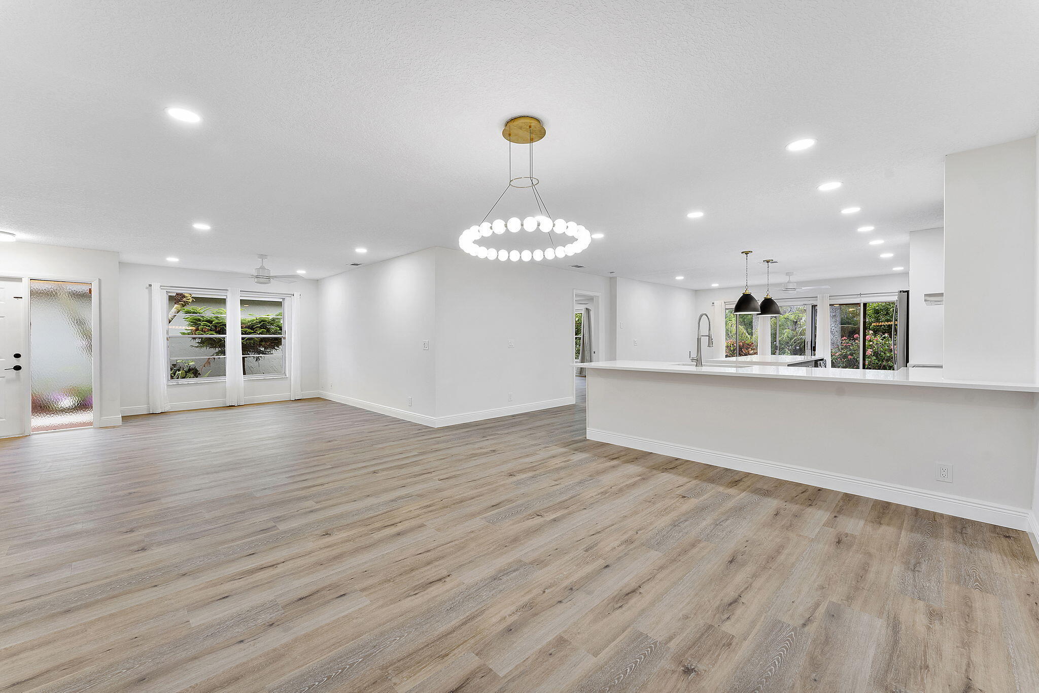 9180 Pine Springs Drive Boca Raton, FL 33428 - Photo 5 of 29 a view of an empty room with window and wooden floor