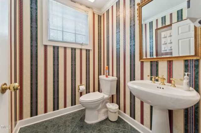 a bathroom with a double vanity sink mirror and toilet