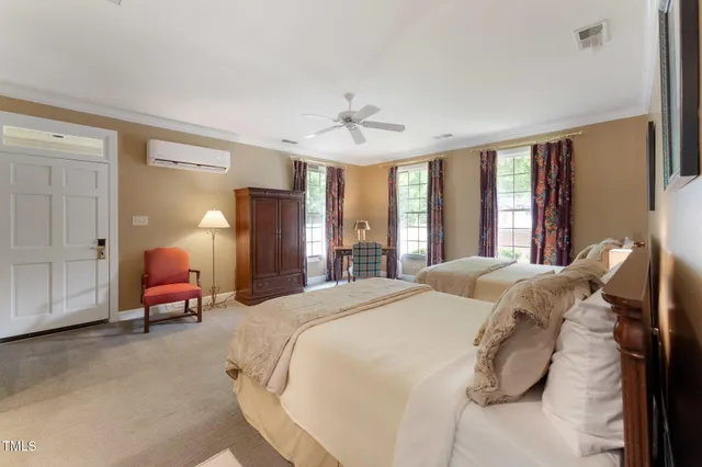 a living room with furniture and large windows