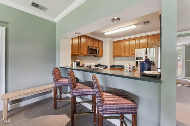 a dining room with furniture and a floor to ceiling window